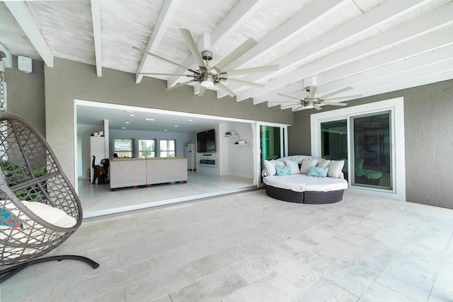 exterior space featuring ceiling fan and beamed ceiling