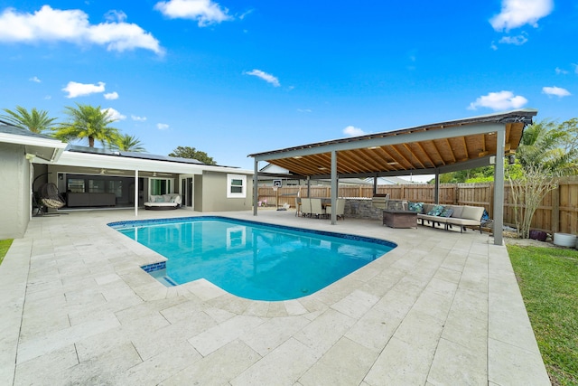 view of swimming pool featuring an outdoor living space with a fire pit and a patio