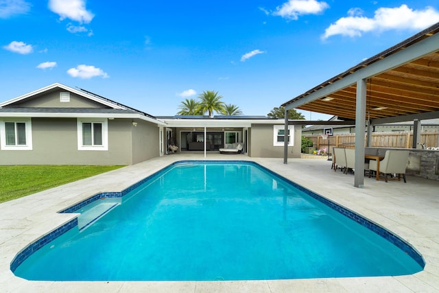 view of pool with exterior bar and a patio