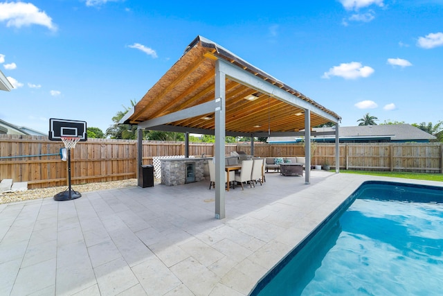 view of swimming pool featuring a patio area and area for grilling