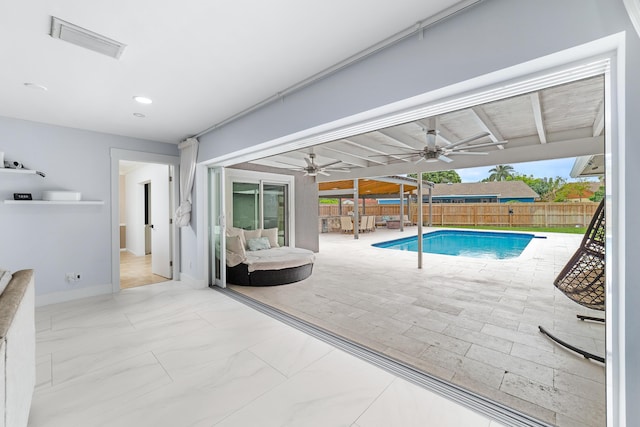 view of swimming pool featuring ceiling fan