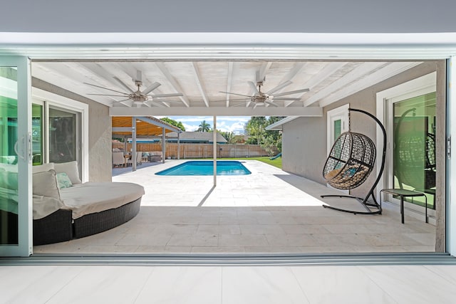 view of pool featuring ceiling fan and a patio