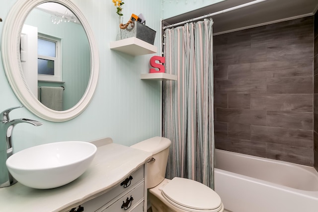 full bathroom featuring shower / bathtub combination with curtain, vanity, and toilet