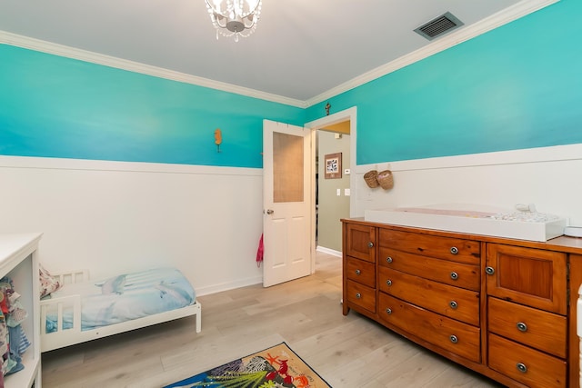 bedroom featuring light hardwood / wood-style flooring and ornamental molding