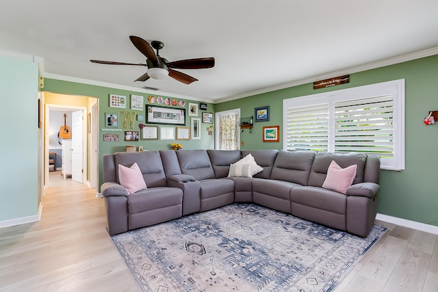 living room with crown molding, ceiling fan, and light hardwood / wood-style flooring