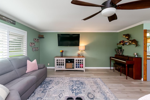 living room featuring ornamental molding, hardwood / wood-style floors, and ceiling fan