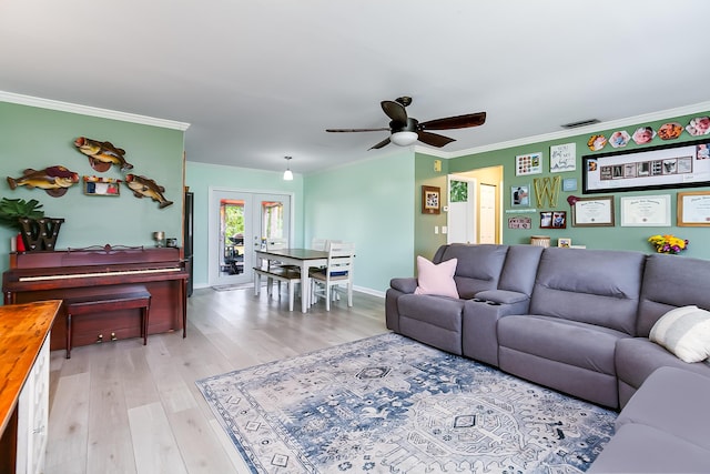 living room featuring french doors, ceiling fan, crown molding, and light hardwood / wood-style flooring