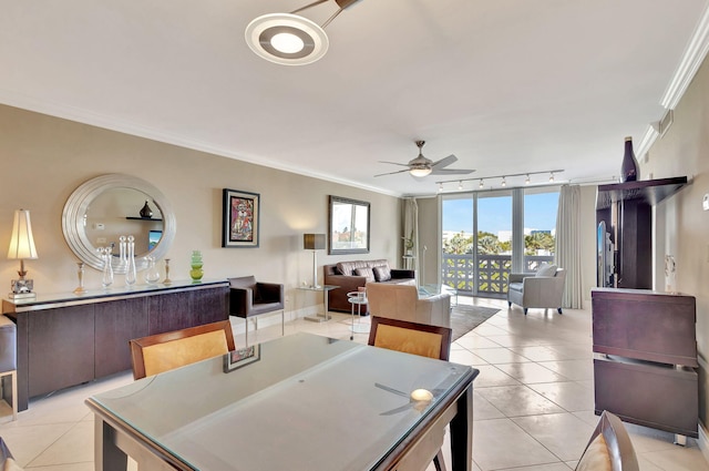 tiled dining area featuring ceiling fan, ornamental molding, and rail lighting