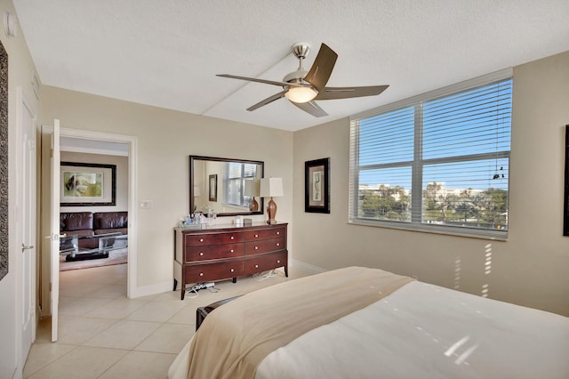 2840 S Ocean Blvd Unit 413, Palm Beach, FL 33480 - bedroom with light tile patterned flooring, ceiling fan, a textured ceiling, and baseboards