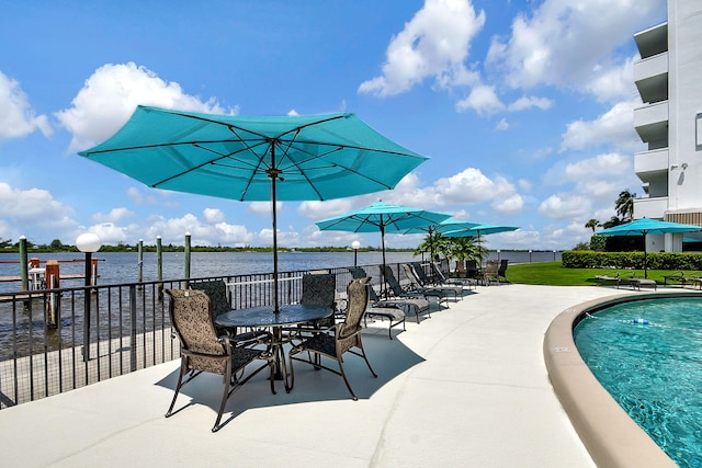 view of patio / terrace with a water view and a community pool