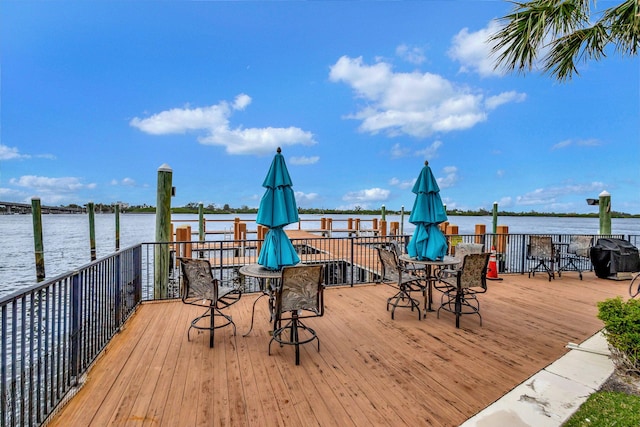 deck with a water view and grilling area