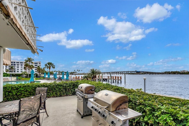 view of patio / terrace with a water view and grilling area