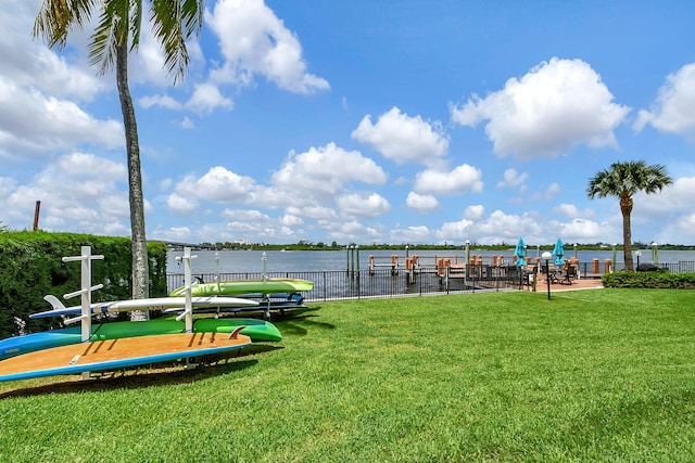 exterior space featuring a lawn and a water view