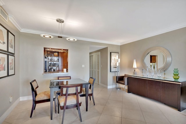 dining area with light tile patterned floors and ornamental molding