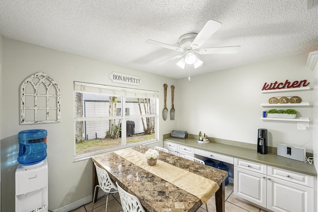 kitchen featuring white cabinetry, a textured ceiling, and light tile patterned flooring