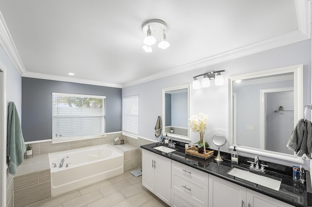 bathroom with ornamental molding, a bathing tub, tile patterned flooring, and vanity