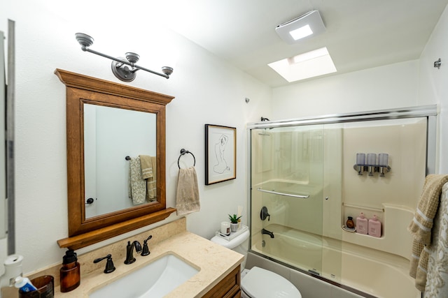 full bathroom featuring shower / bath combination with glass door, vanity, a skylight, and toilet