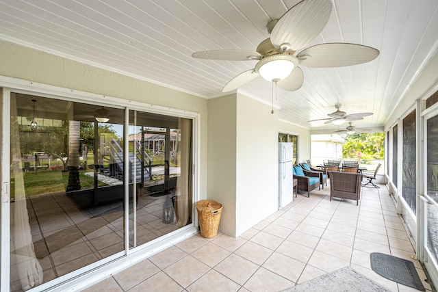 unfurnished sunroom with ceiling fan and wood ceiling