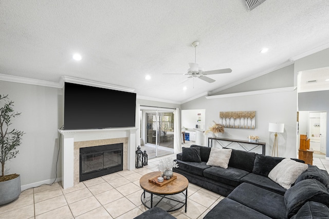 tiled living room featuring a tiled fireplace, a textured ceiling, vaulted ceiling, and ornamental molding