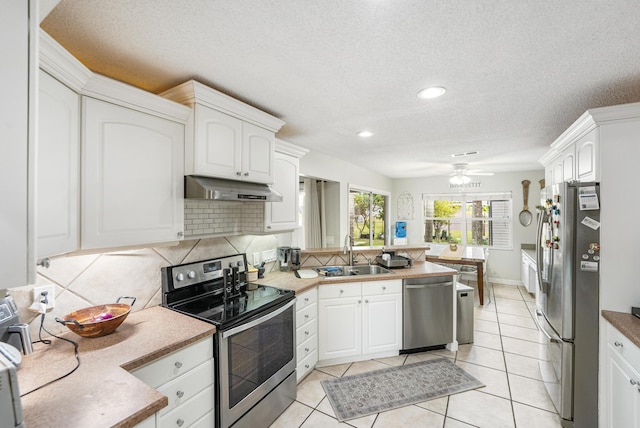 kitchen featuring sink, white cabinetry, decorative backsplash, and appliances with stainless steel finishes