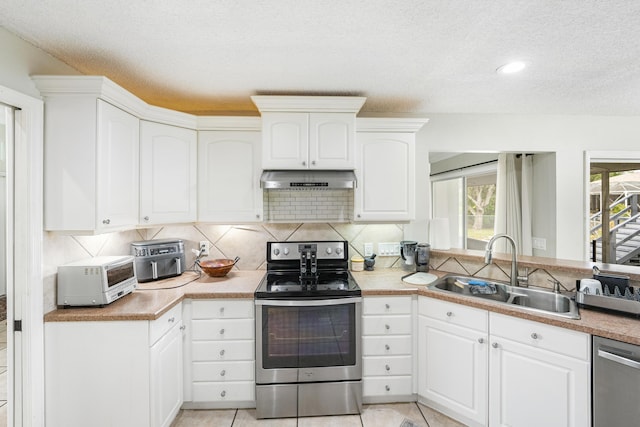 kitchen with sink, white cabinetry, a textured ceiling, and appliances with stainless steel finishes