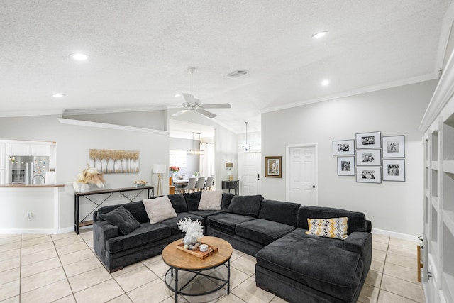 living room with a textured ceiling, light tile patterned floors, crown molding, and vaulted ceiling