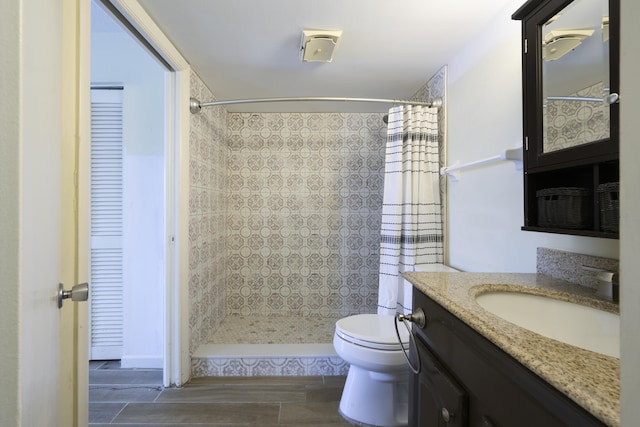 bathroom with vanity, walk in shower, and toilet