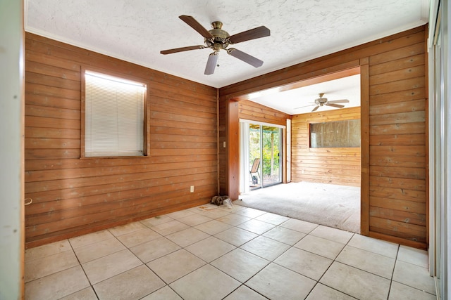 interior space with lofted ceiling, a textured ceiling, and wood walls