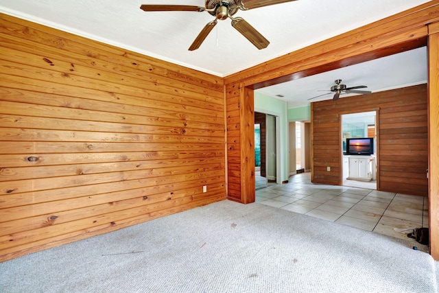 spare room featuring light carpet and wooden walls