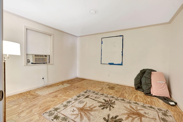 unfurnished room featuring hardwood / wood-style flooring, ornamental molding, and cooling unit