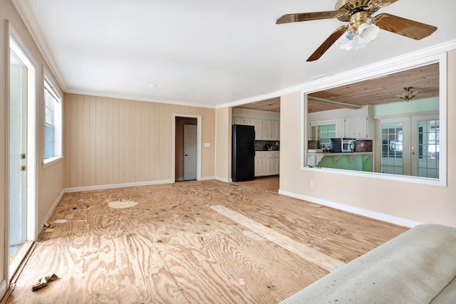 unfurnished living room featuring crown molding and ceiling fan