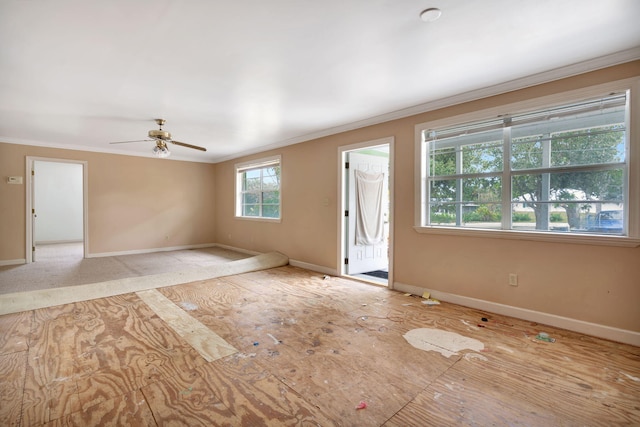 unfurnished room featuring plenty of natural light, ornamental molding, and ceiling fan