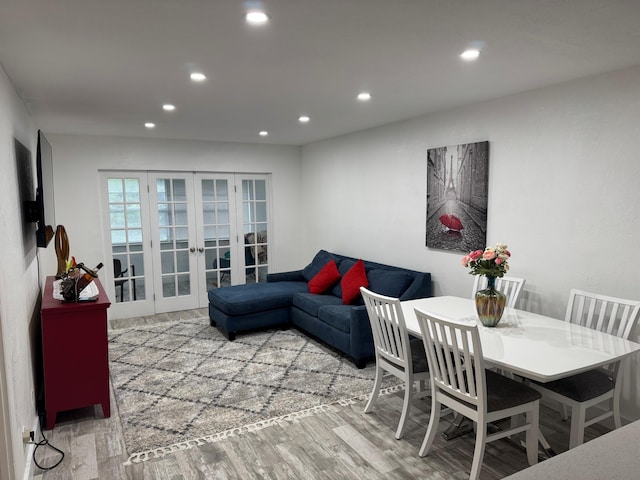 living room with light hardwood / wood-style floors and french doors