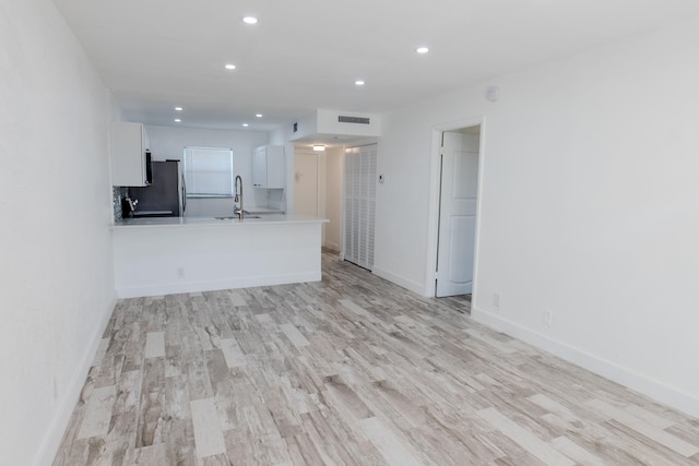 interior space with sink and light hardwood / wood-style floors