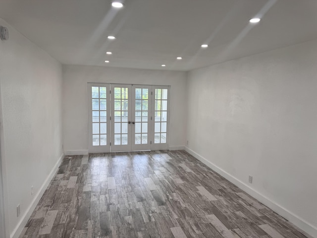 empty room featuring french doors and dark hardwood / wood-style floors