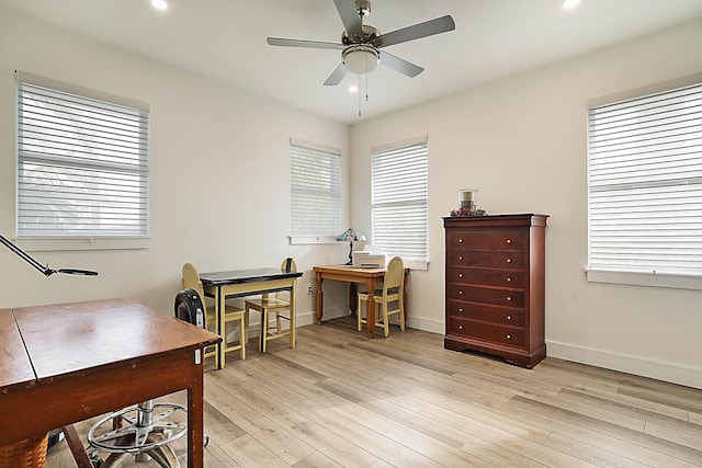 office area with ceiling fan and light hardwood / wood-style floors