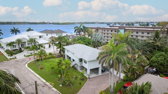 drone / aerial view with a residential view and a water view