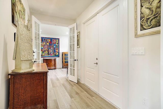 hallway featuring light hardwood / wood-style floors and french doors