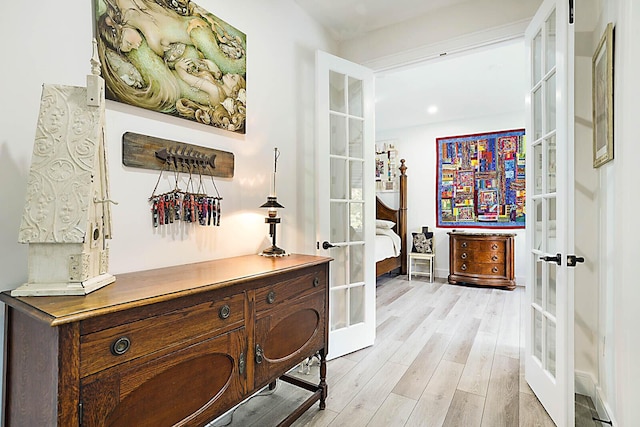 hallway with french doors and light wood finished floors