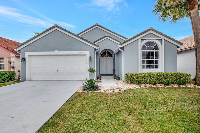 view of front facade with a front yard and a garage