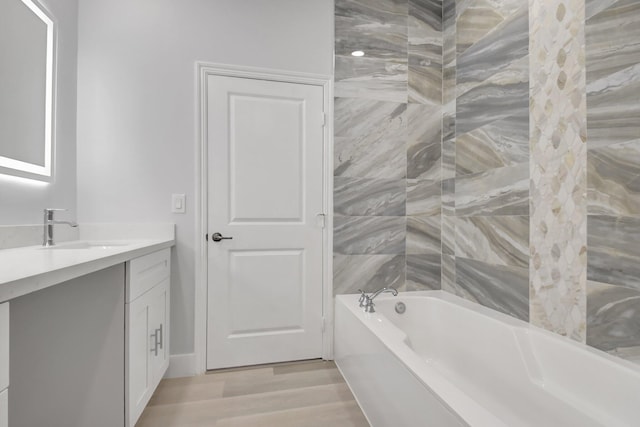 bathroom with vanity, hardwood / wood-style flooring, and  shower combination