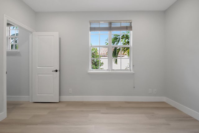 spare room featuring light hardwood / wood-style flooring