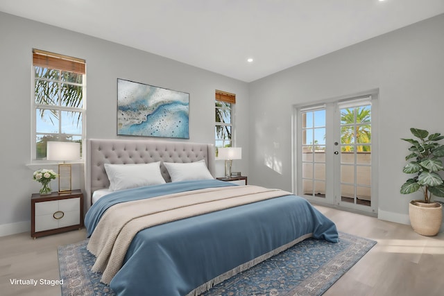 bedroom with french doors, access to exterior, multiple windows, and light wood-type flooring