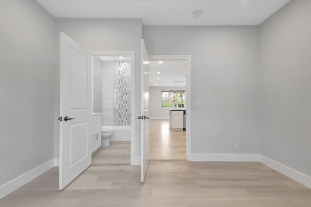 corridor with light hardwood / wood-style flooring