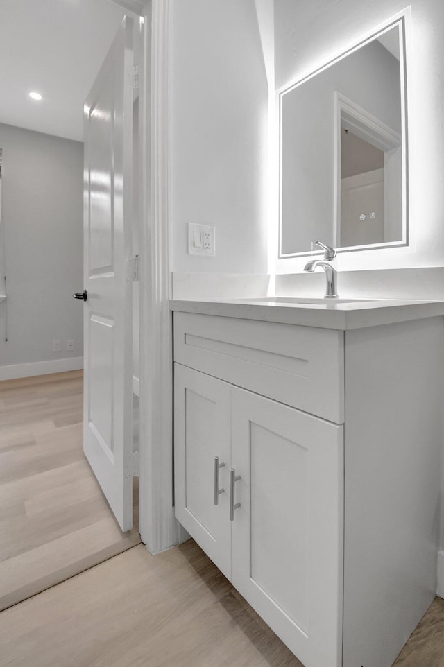 bathroom featuring vanity and hardwood / wood-style floors