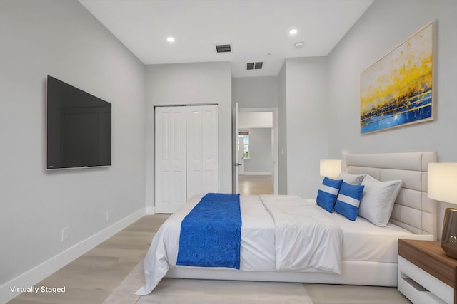 bedroom featuring light hardwood / wood-style flooring and a closet