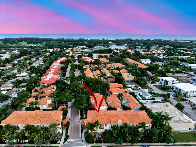 aerial view at dusk with a water view