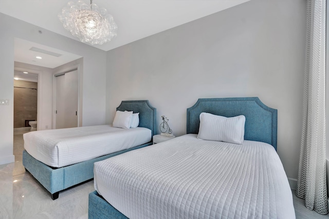 bedroom with a chandelier and ensuite bathroom