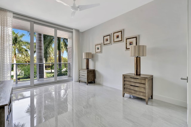 interior space featuring expansive windows and ceiling fan