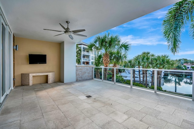 view of patio featuring a balcony and ceiling fan